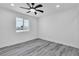 Bright bedroom featuring a ceiling fan, window, and modern flooring at 5580 Waltham Ln, Las Vegas, NV 89122