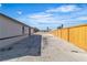 Long concrete driveway leads to a large backyard area with newly installed wooden fence at 5580 Waltham Ln, Las Vegas, NV 89122