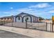 Charming home featuring a secure fence, desert landscaping, and unique window accents at 5580 Waltham Ln, Las Vegas, NV 89122