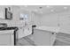 Bright kitchen with white cabinets, stainless steel appliances, and stone countertops at 5580 Waltham Ln, Las Vegas, NV 89122