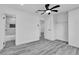 Spacious bedroom with ceiling fan, modern flooring, and attached bath at 5580 Waltham Ln, Las Vegas, NV 89122