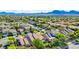 A scenic view of a suburban neighborhood featuring lush landscaping and mountain views at 602 Painted Cloud Pl, Las Vegas, NV 89144