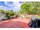 Private backyard featuring a patio, mature trees, and a well-maintained garden, perfect for relaxing or entertaining outdoors at 602 Painted Cloud Pl, Las Vegas, NV 89144
