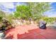 Enclosed backyard with patio, privacy wall, and mature landscaping at 602 Painted Cloud Pl, Las Vegas, NV 89144