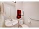Cozy bathroom with pedestal sink, a mirrored cabinet, and essential fixtures at 602 Painted Cloud Pl, Las Vegas, NV 89144