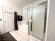 Bathroom with tub and glass-enclosed shower, complemented by white tile and a plush rug at 602 Painted Cloud Pl, Las Vegas, NV 89144
