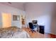 Bright bedroom features wood floors, a workspace, and doorway leading to other rooms at 602 Painted Cloud Pl, Las Vegas, NV 89144