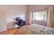 Cozy bedroom featuring wood floors, a work space, and a large window with natural light at 602 Painted Cloud Pl, Las Vegas, NV 89144
