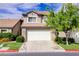Charming two-story home featuring a two-car garage, well-maintained lawn and stone veneer accents at 602 Painted Cloud Pl, Las Vegas, NV 89144