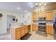 Charming kitchen featuring ample counter space, stainless steel appliances, and natural wood cabinets at 602 Painted Cloud Pl, Las Vegas, NV 89144