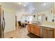 Open kitchen showcasing stainless steel appliances, a breakfast bar, and seamlessly connected dining area at 602 Painted Cloud Pl, Las Vegas, NV 89144