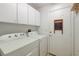 Bright laundry room with lots of storage space, including a washer and dryer at 602 Painted Cloud Pl, Las Vegas, NV 89144
