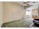 Carpeted living room featuring seating and a ceiling fan with access to the stairs at 602 Painted Cloud Pl, Las Vegas, NV 89144