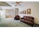 Carpeted living room featuring seating and a ceiling fan for a comfortable atmosphere at 602 Painted Cloud Pl, Las Vegas, NV 89144