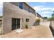 Backyard shows stucco home with a sliding glass door and tan fence at 6260 Castle Kennedy St, Henderson, NV 89011