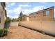 Backyard features a tan fence, air conditioning units, and a neighboring house at 6260 Castle Kennedy St, Henderson, NV 89011