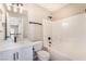 A clean bathroom featuring modern fixtures, a white marble vanity, and a shower-tub combination at 6260 Castle Kennedy St, Henderson, NV 89011