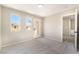 Bright bedroom with carpeted floors, multiple windows, a glass paneled door with exterior views, and neutral walls at 6260 Castle Kennedy St, Henderson, NV 89011