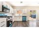 Bright kitchen boasts white cabinets, modern appliances, and backyard access at 6260 Castle Kennedy St, Henderson, NV 89011