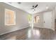 Bright living room features with multiple windows and hardwood floors throughout at 6260 Castle Kennedy St, Henderson, NV 89011