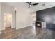 Bright living room features a fireplace with black accent wall and modern ceiling fan at 6260 Castle Kennedy St, Henderson, NV 89011