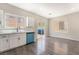 Open living space with wood-look floors, big windows, and sliding glass door at 6260 Castle Kennedy St, Henderson, NV 89011