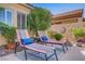 Cozy patio featuring two colorful lounge chairs and small table, creating a relaxing outdoor space at 6440 Bristlebird St, North Las Vegas, NV 89084