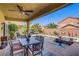 Backyard patio features outdoor dining and lounge furniture, a pool, and lush landscaping at 6440 Bristlebird St, North Las Vegas, NV 89084