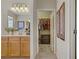 Bathroom featuring double sinks, wooden cabinets, and an open doorway to a closet at 6440 Bristlebird St, North Las Vegas, NV 89084