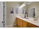 Bathroom with double sinks, framed mirror and artistic decor at 6440 Bristlebird St, North Las Vegas, NV 89084