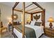 Comfortable bedroom boasts a wooden canopy bed, side tables and soft lighting at 6440 Bristlebird St, North Las Vegas, NV 89084