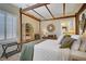 Well-decorated bedroom featuring a wooden canopy bed, shelves, and plantation shutters at 6440 Bristlebird St, North Las Vegas, NV 89084