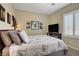 Comfortable bedroom showcases neutral walls and a queen bed with unique duvet cover at 6440 Bristlebird St, North Las Vegas, NV 89084