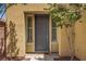 Welcoming front entrance featuring a neutral-colored door, side windows, and desert landscaping at 6440 Bristlebird St, North Las Vegas, NV 89084