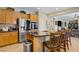Open kitchen featuring stainless steel appliances and granite countertop island with barstool seating at 6440 Bristlebird St, North Las Vegas, NV 89084
