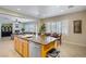 Open concept featuring kitchen with bar top, dining area, and living room with plenty of natural light at 6440 Bristlebird St, North Las Vegas, NV 89084