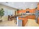 Bright kitchen with stainless steel appliances, a center island, and an adjacent dining area at 6440 Bristlebird St, North Las Vegas, NV 89084