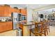 Gourmet kitchen boasts stainless appliances, granite counters and a central island with seating at 6440 Bristlebird St, North Las Vegas, NV 89084