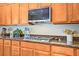 Modern kitchen with stainless steel appliances, granite countertops, and custom cabinetry at 6440 Bristlebird St, North Las Vegas, NV 89084