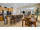 Open concept kitchen and dining area with granite countertops and stainless steel appliances at 6440 Bristlebird St, North Las Vegas, NV 89084