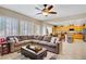 Cozy living room with large sectional sofa and open access to the kitchen at 6440 Bristlebird St, North Las Vegas, NV 89084
