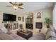 Relaxing living room with a fireplace, media console, and stylish furniture at 6440 Bristlebird St, North Las Vegas, NV 89084