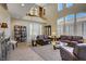 Spacious living room featuring a soaring two-story ceiling and staircase to the second floor at 6440 Bristlebird St, North Las Vegas, NV 89084