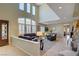 Bright living room with vaulted ceilings, lots of natural light, and views to dining room at 6440 Bristlebird St, North Las Vegas, NV 89084