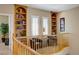 Cozy loft area with bookshelves and two chairs perfect for relaxing at 6440 Bristlebird St, North Las Vegas, NV 89084