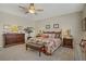 Well-lit primary bedroom features a king-sized bed, two dressers, and carpeted floors at 6440 Bristlebird St, North Las Vegas, NV 89084