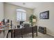 Well-lit home office with a large desk and ample workspace at 6440 Bristlebird St, North Las Vegas, NV 89084