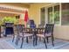 Comfortable patio with a table, chairs, grill and a red umbrella, ideal for outdoor dining and entertaining at 6440 Bristlebird St, North Las Vegas, NV 89084