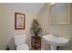 Convenient powder room with pedestal sink and stylish decor at 6440 Bristlebird St, North Las Vegas, NV 89084