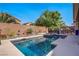 Sparkling swimming pool and spa surrounded by mature landscaping and a block wall for privacy at 6440 Bristlebird St, North Las Vegas, NV 89084